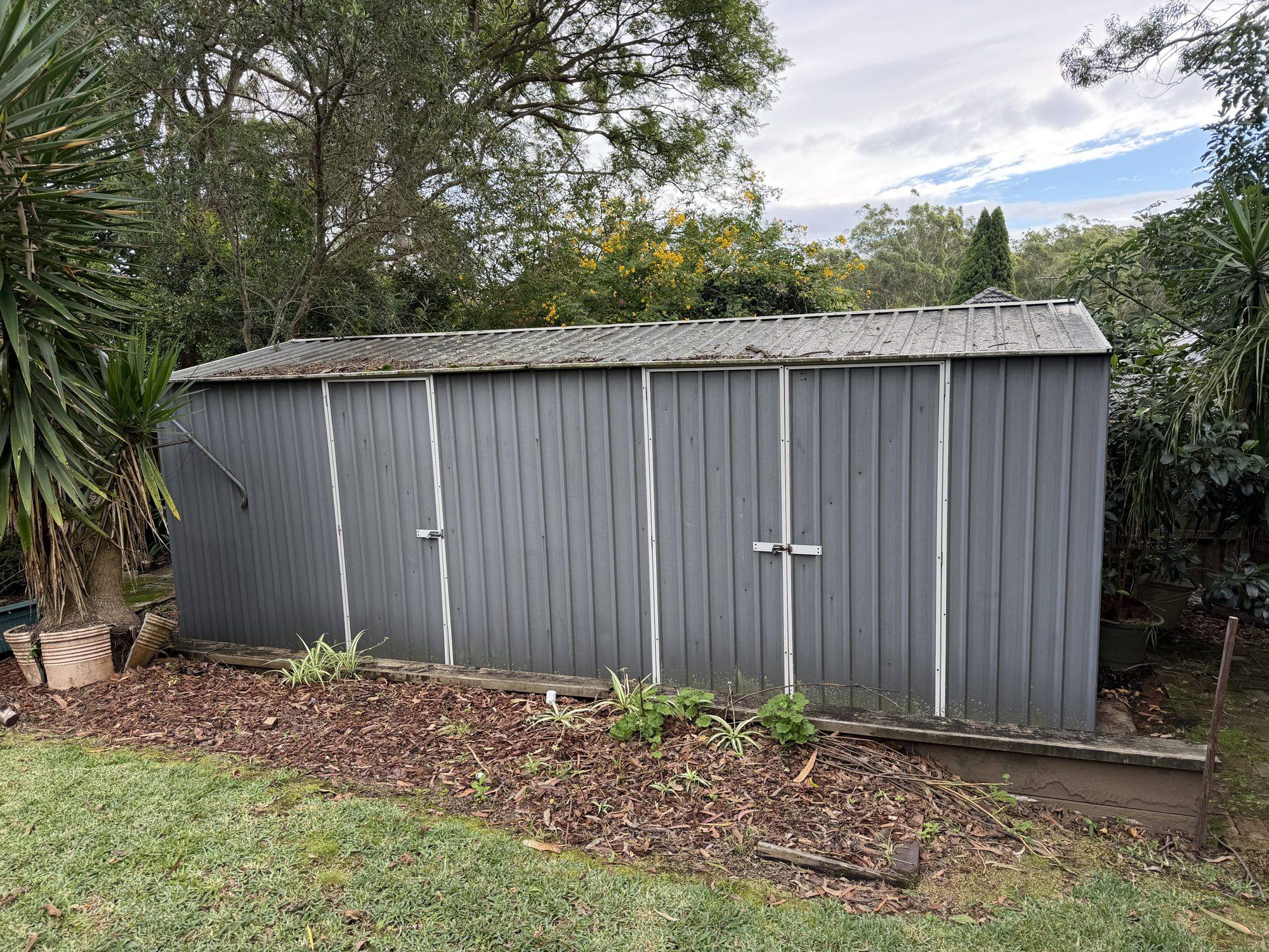 Steel garden shed in the backyard before removal