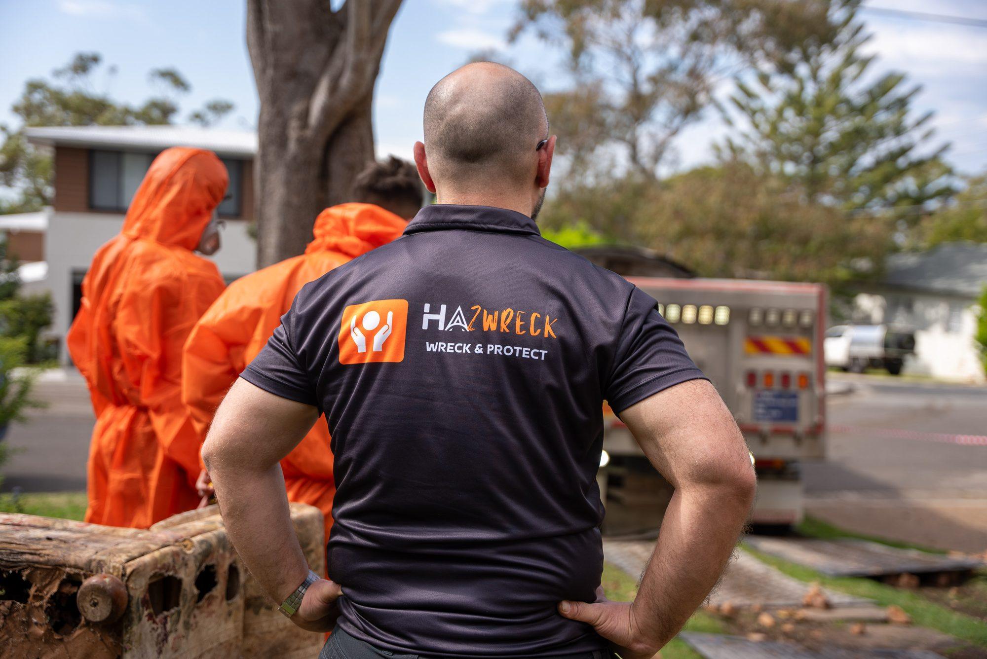 HazWreck supervisor watching two crew members in PPE walk back to the truck on a Sydney street