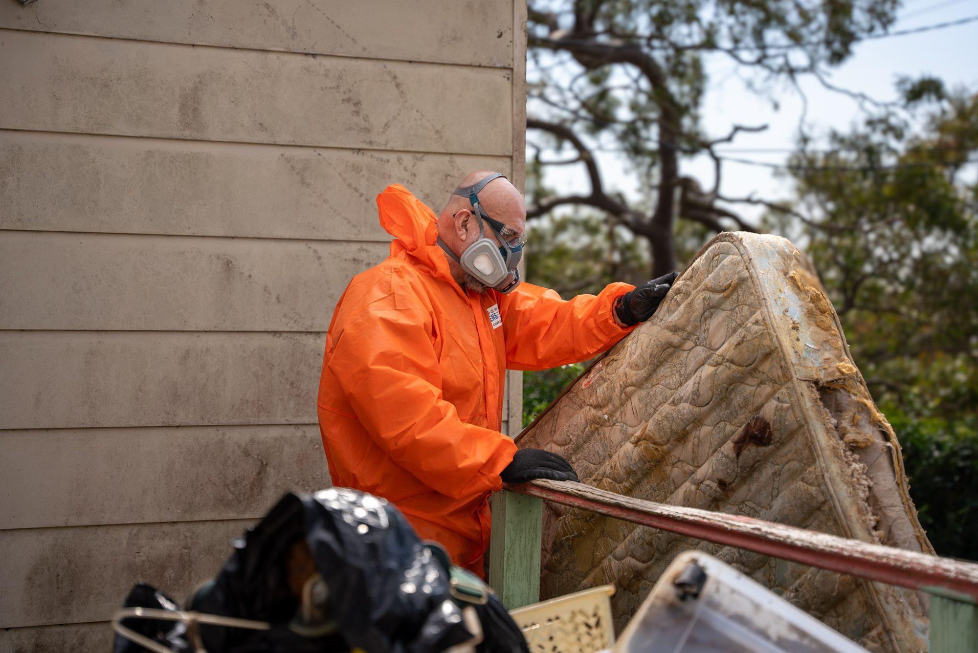 HazWreck crew member moving an old mattress out of a Sydney home during a house clearance