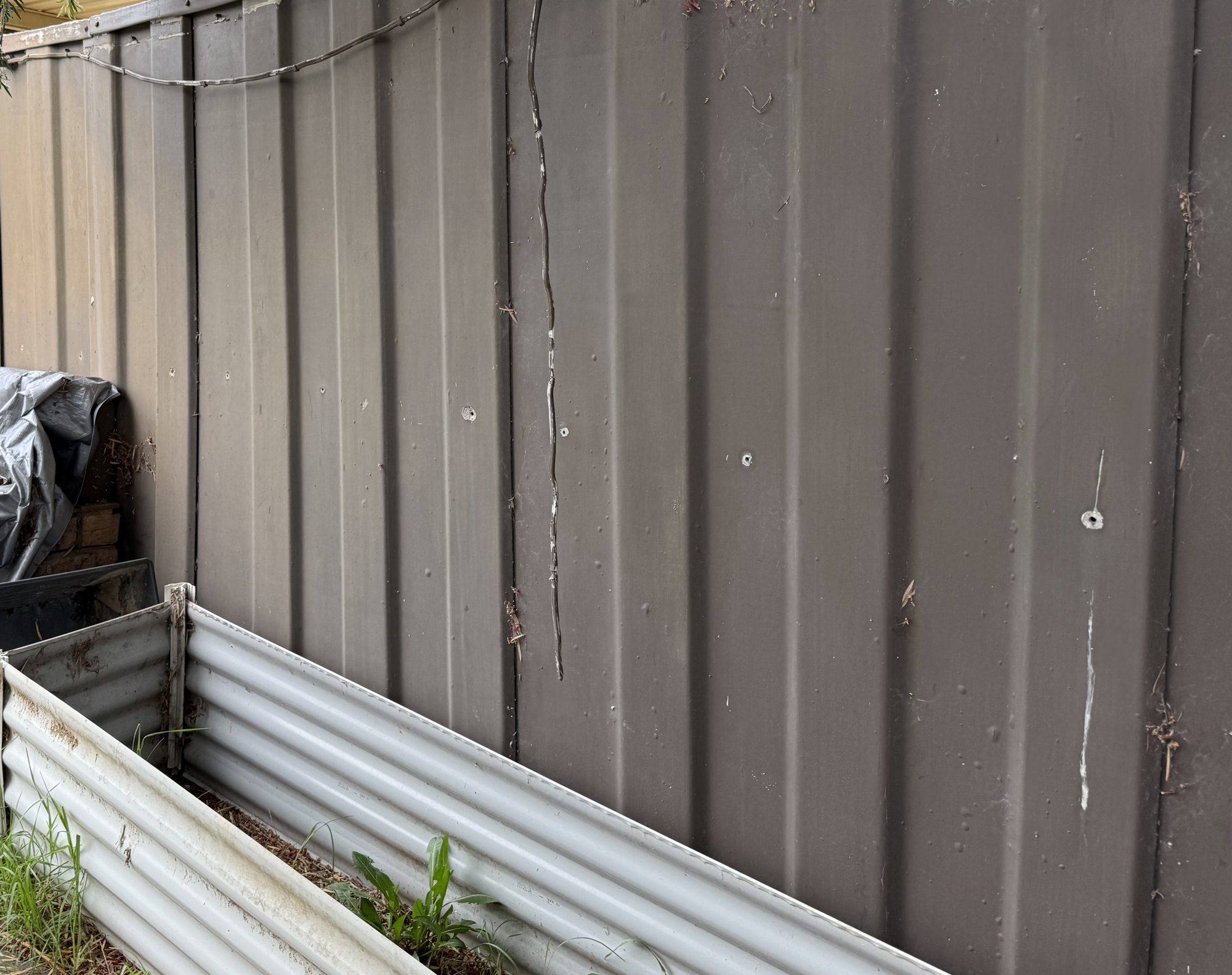 Asbestos-cement boundary fence at a South Penrith home before removal
