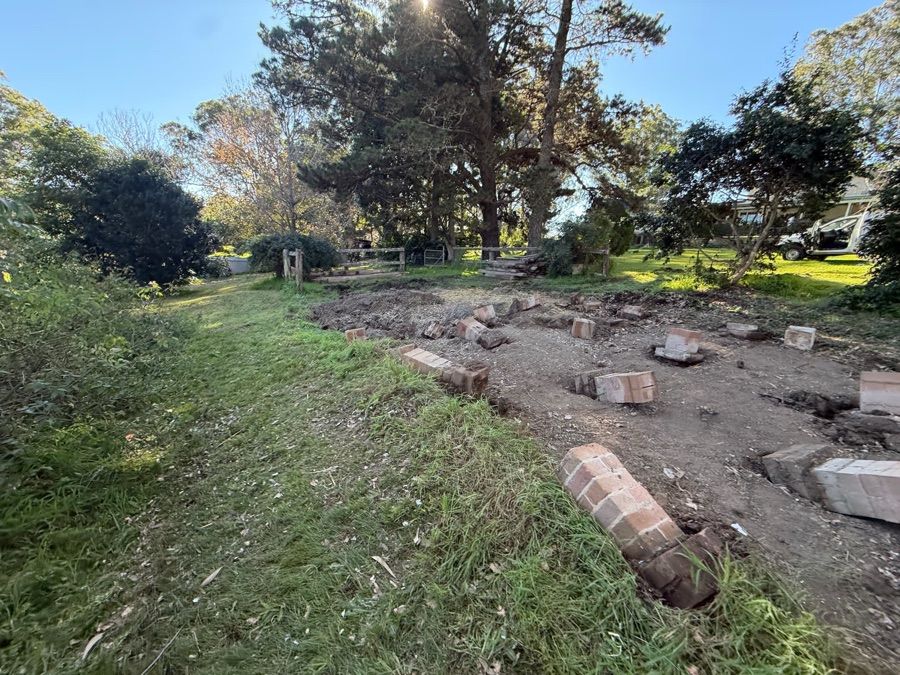 Brick pier footings exposed after an asbestos shed was removed, before site clearance