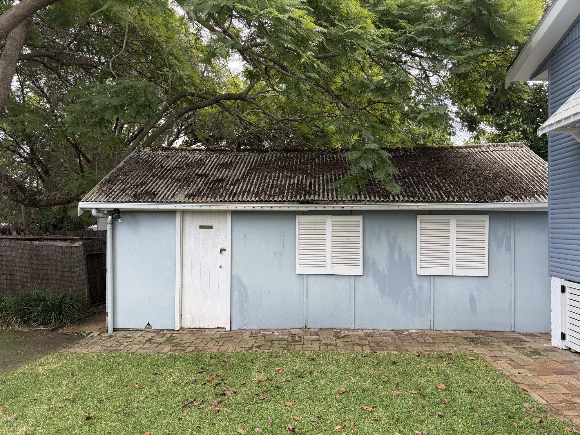 Fibro garage with a weathered Super Six asbestos-cement roof before removal