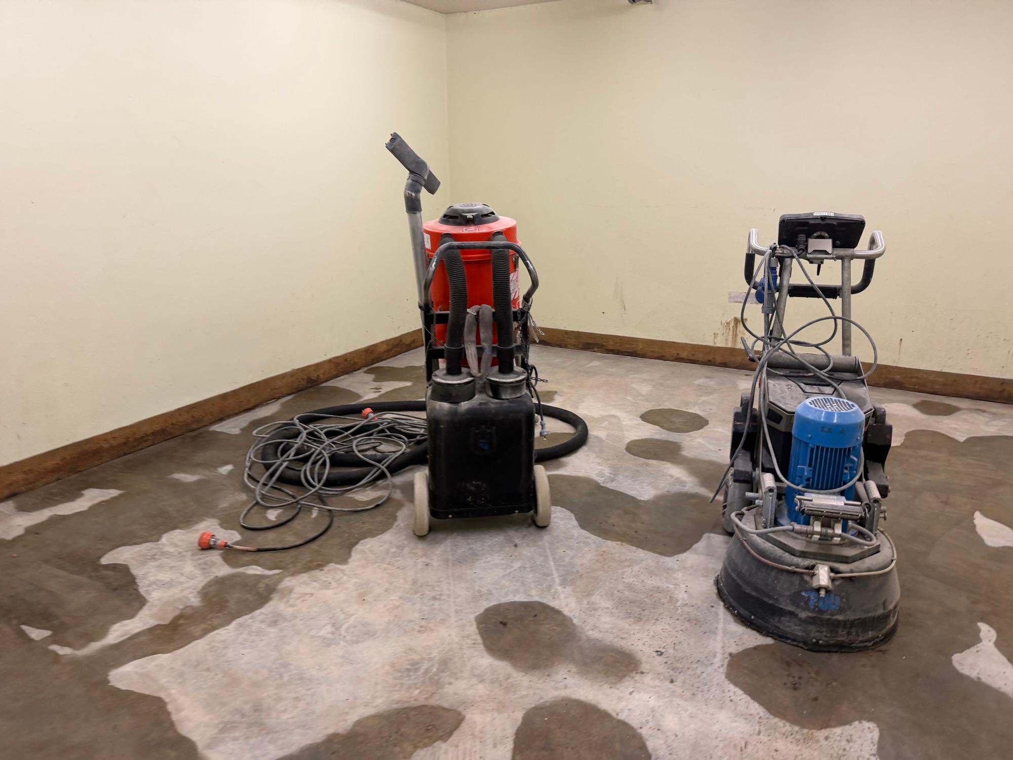 Planetary floor grinder and dust extractors on a part-ground slab during a Gladesville gym defit