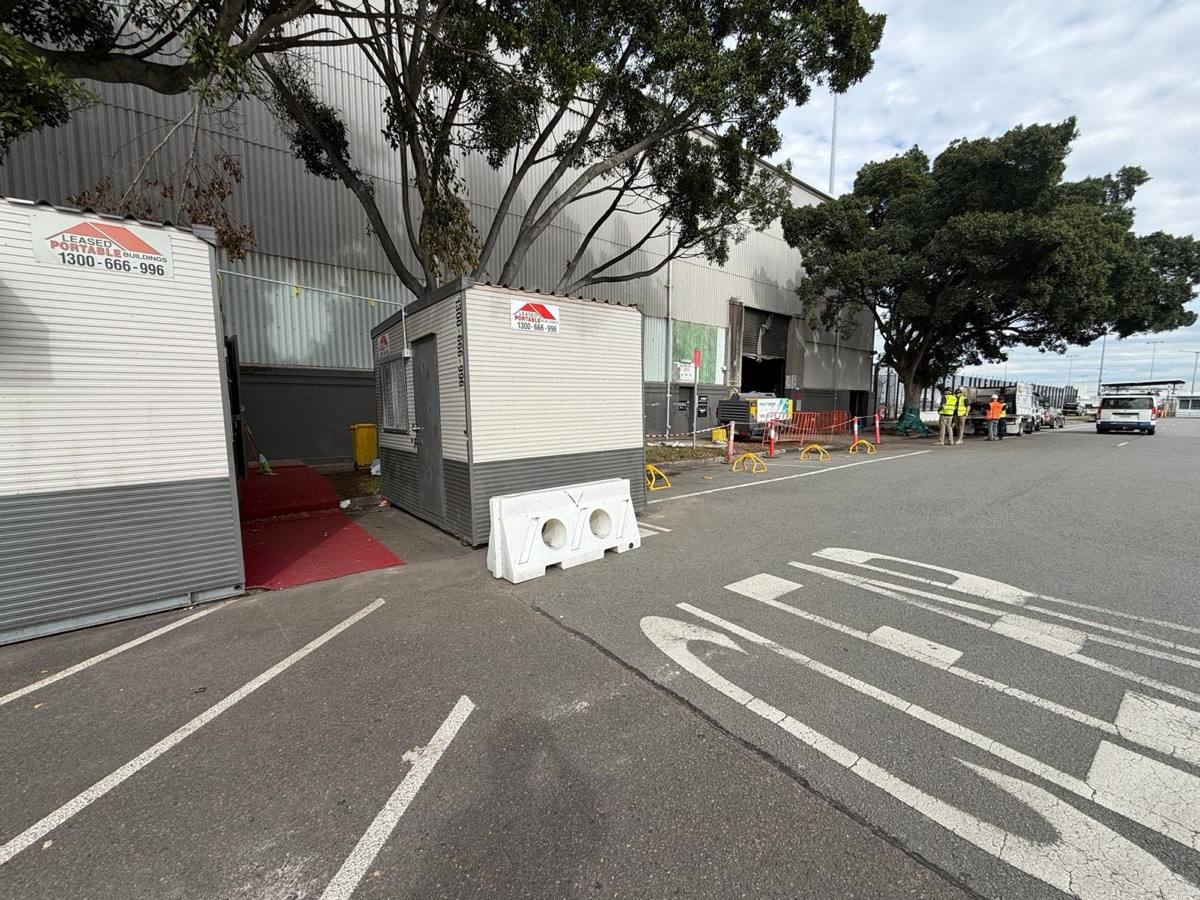 Roadway and parking bays reopened outside Hangar 3 with the temporary fencing removed