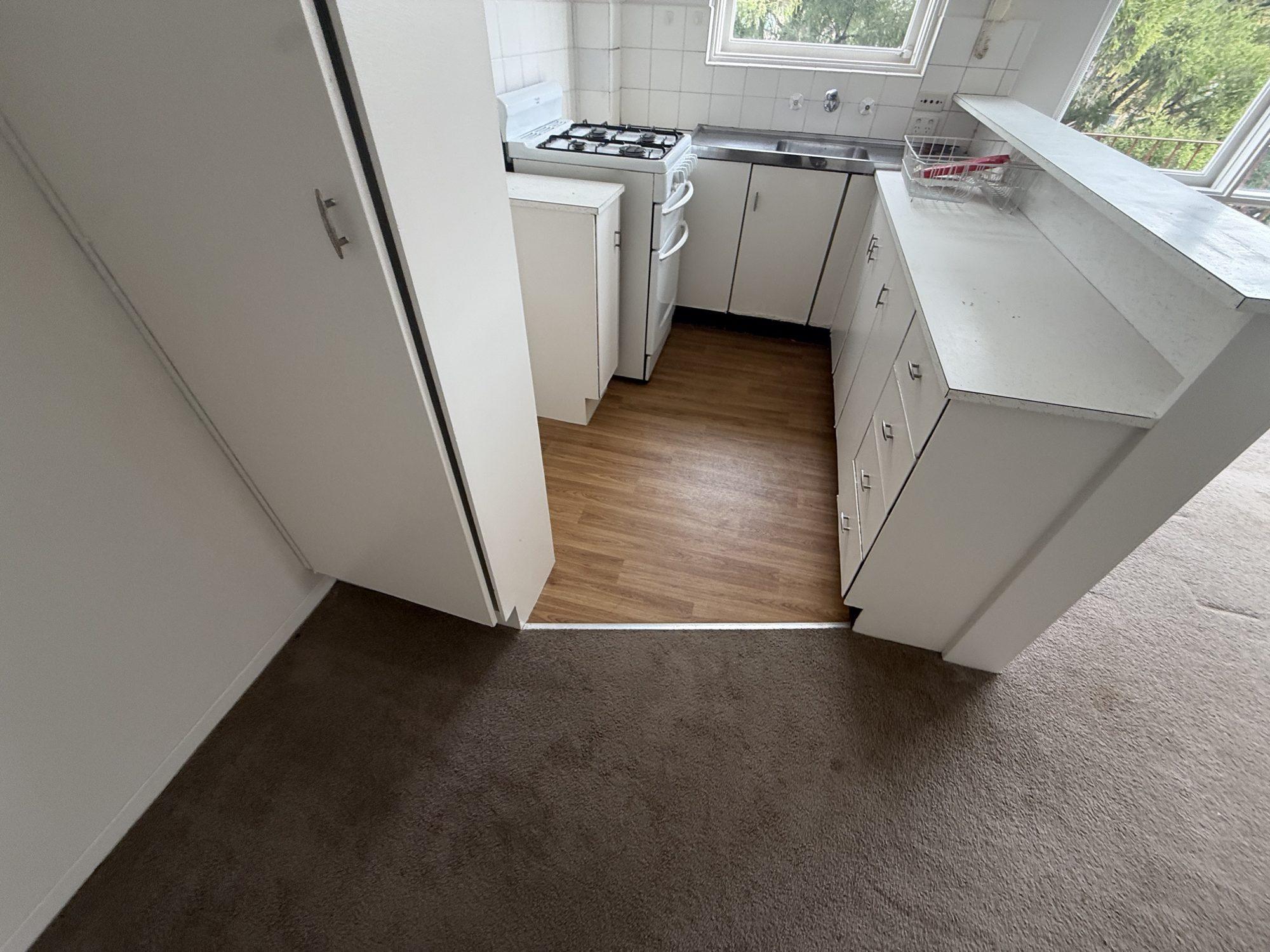 Original kitchen joinery and vinyl floor in the vacant Crows Nest apartment before removal