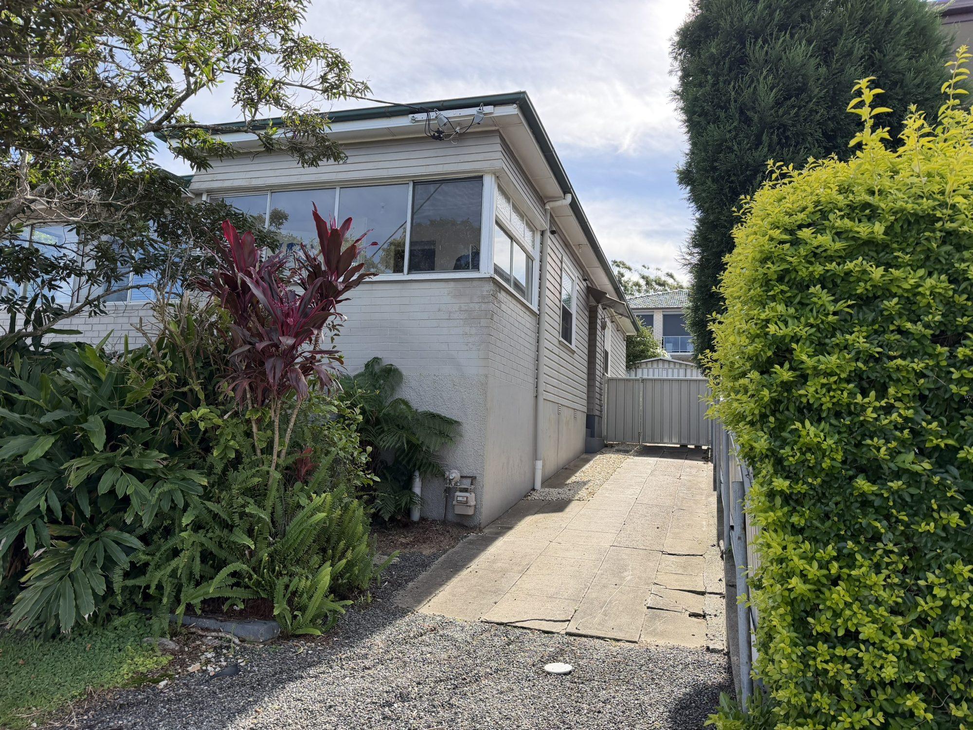 The front of the Lambton house with established gardens before demolition