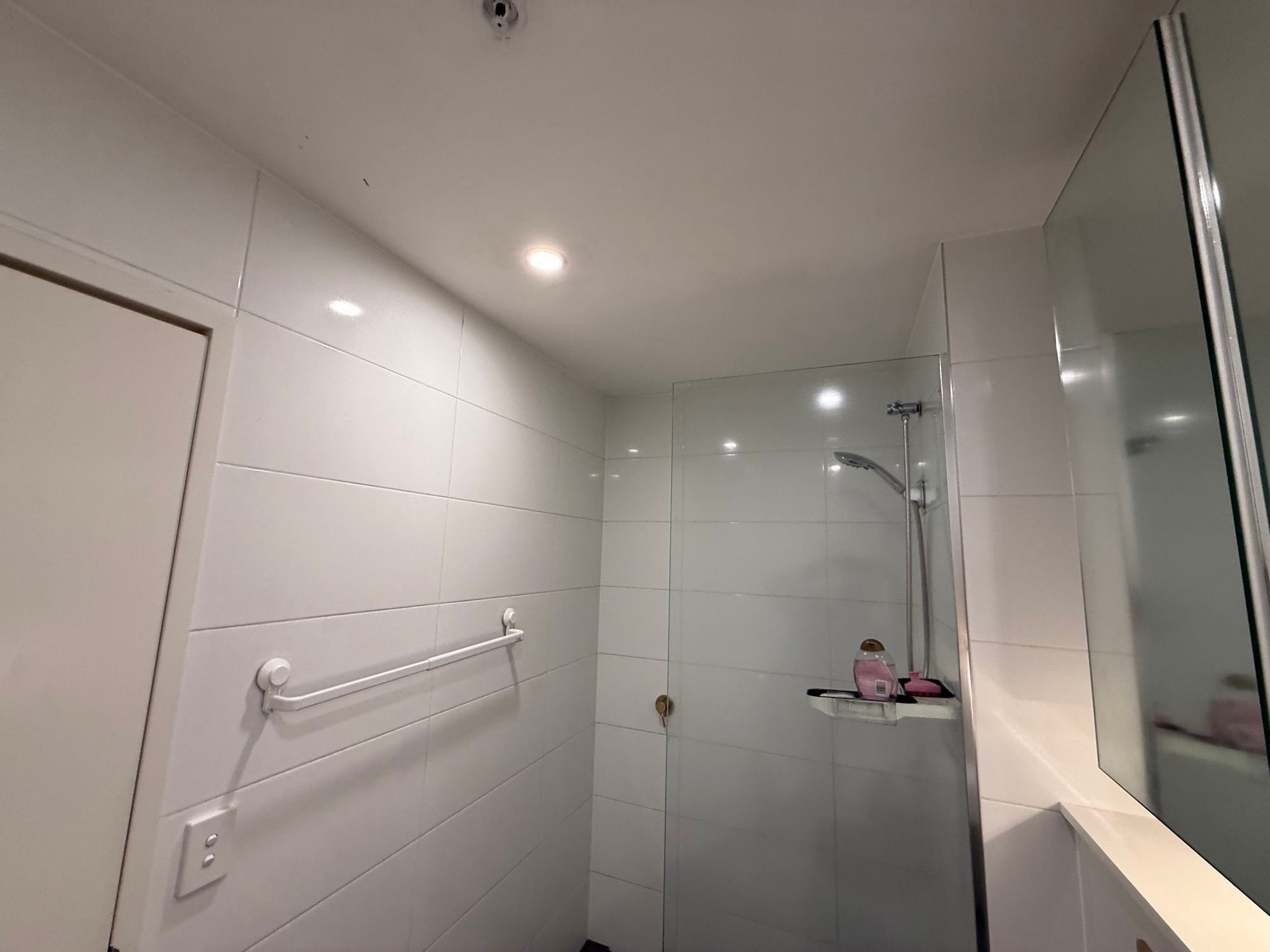 The same ceiling above the shower screen clean and white after remediation