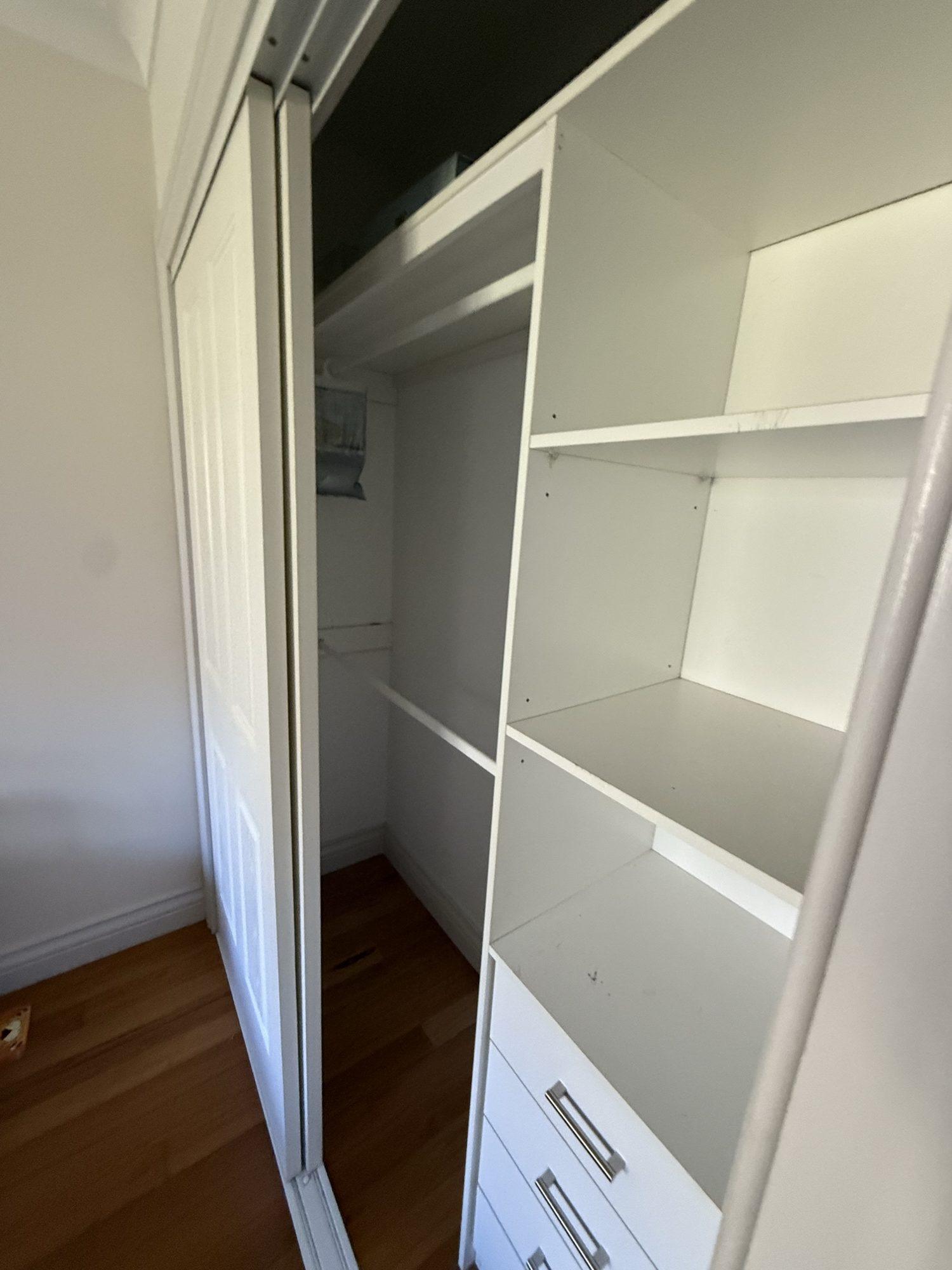 Clean, empty wardrobe shelving after mould remediation in Dural
