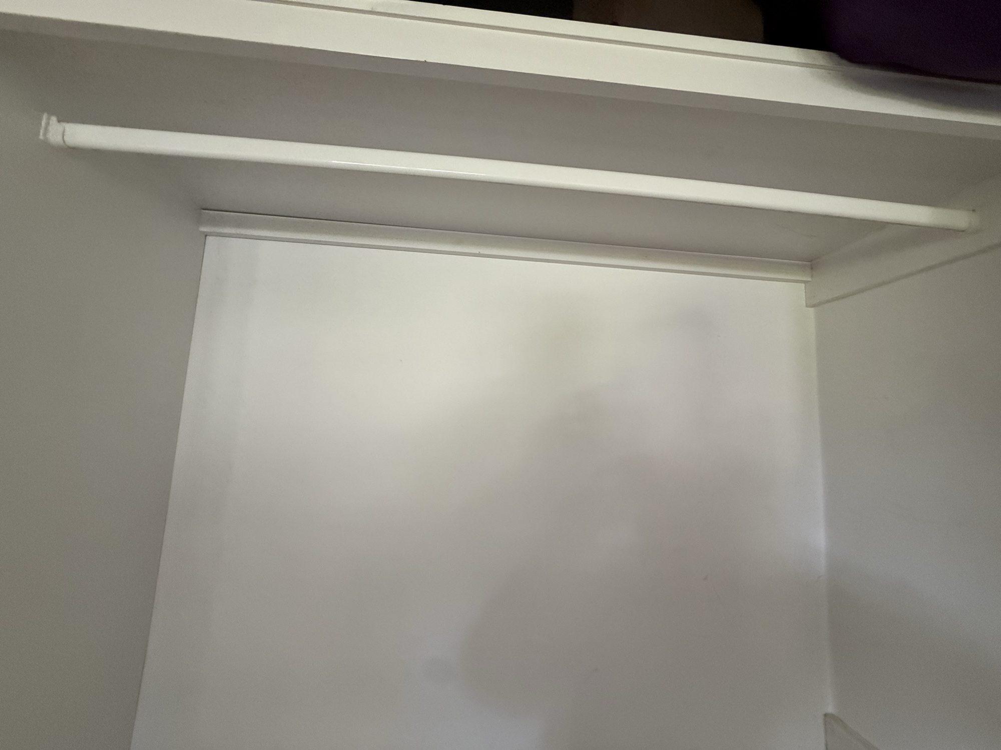Top shelf and ceiling inside a built-in wardrobe showing mould growth