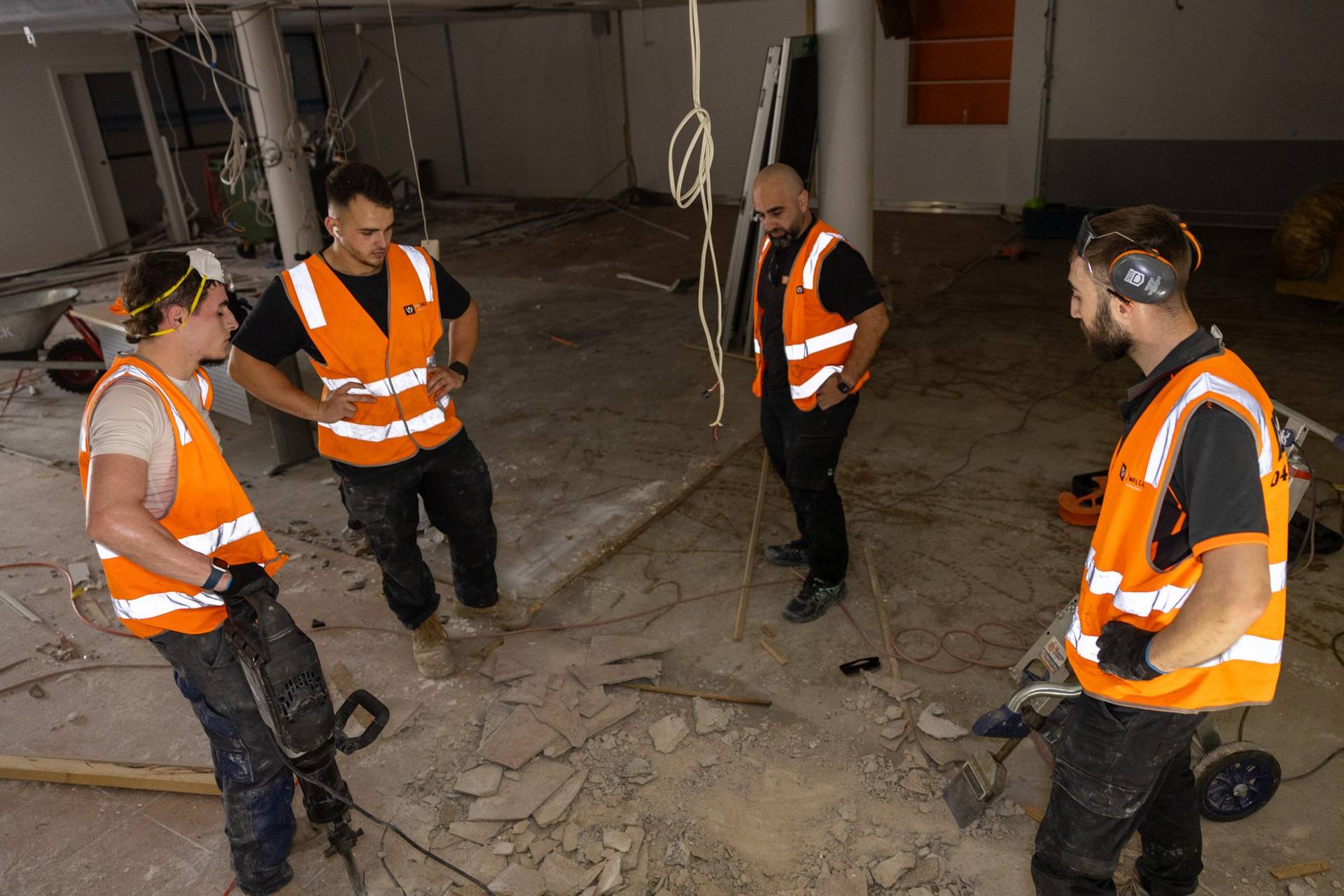HazWreck crew planning the next task on site at the Plus Fitness Manly Vale strip-out
