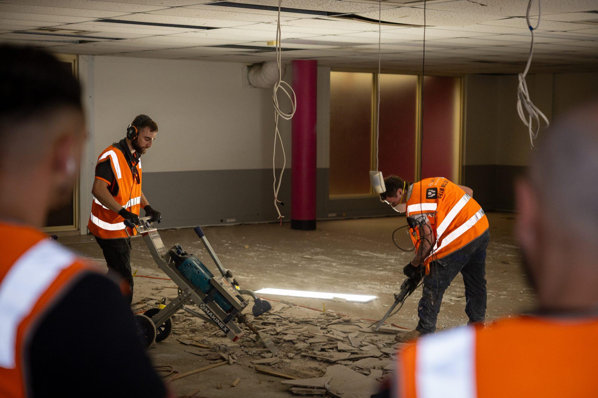 HazWreck crew breaking up and clearing the floor inside the Plus Fitness Manly Vale tenancy