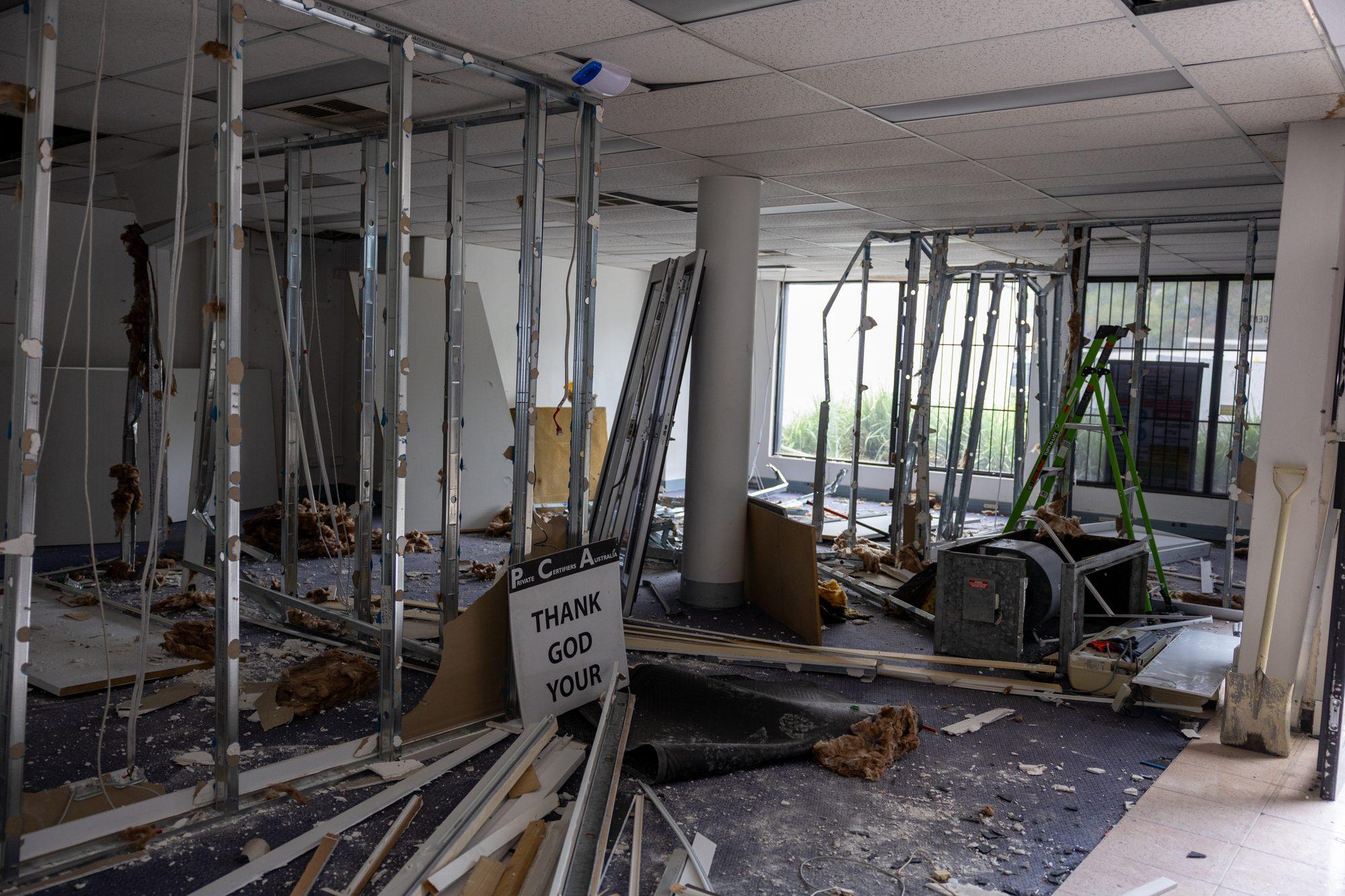 Stripped-back steel stud walls inside the Plus Fitness Manly Vale tenancy during demolition