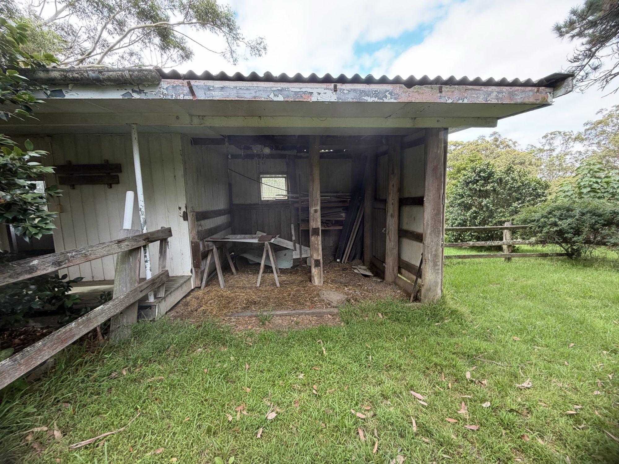 Front of the shed showing the corrugated Super Six asbestos roof sheets and open bays