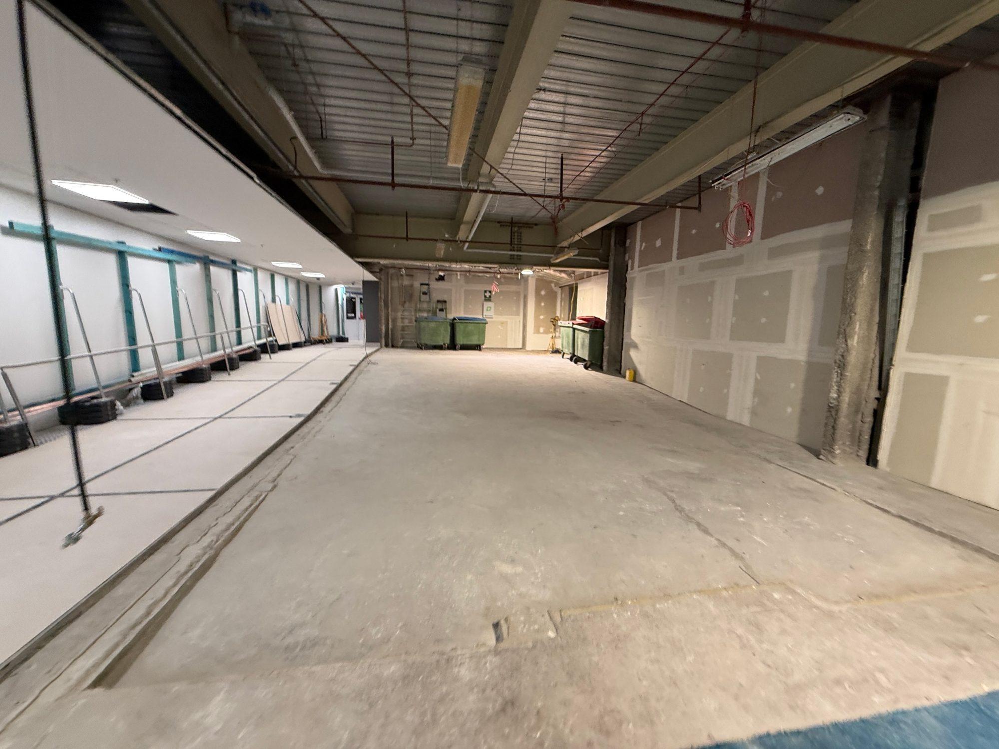 Long back-of-house area at Sydney Airport T1 cleared and swept back to the slab