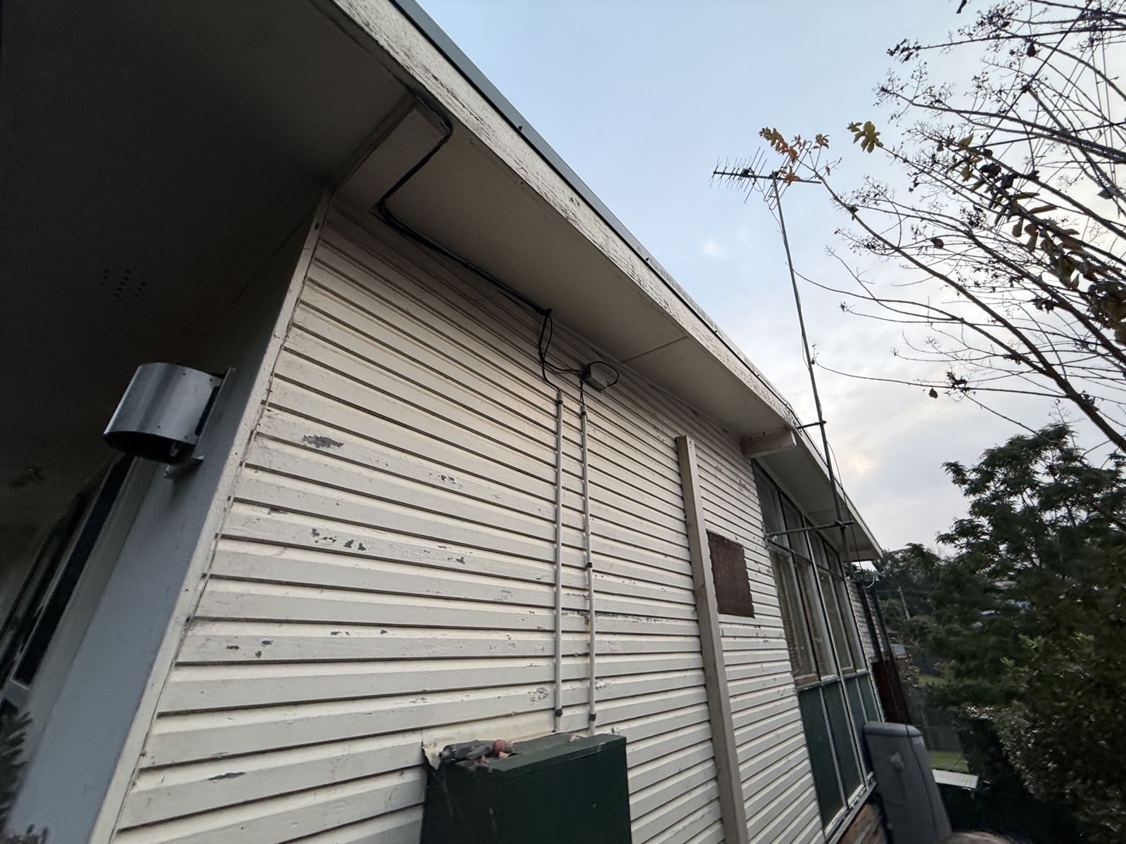 Fibro-clad house in Asquith with asbestos-cement eaves, photographed on the inspection visit before removal